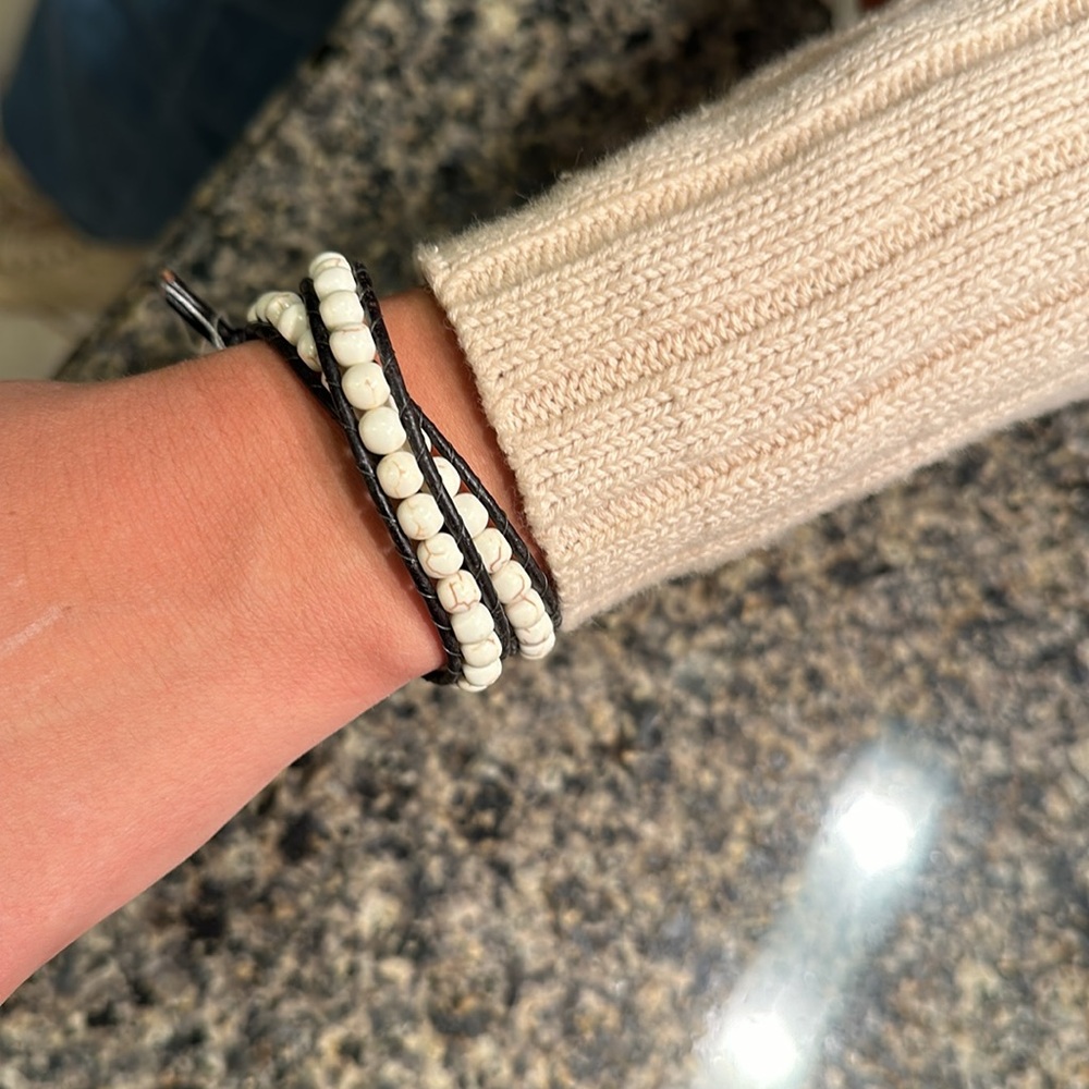 Artisan leather wrap bracelet with genuine howlite gemstones. Gold lotus flower